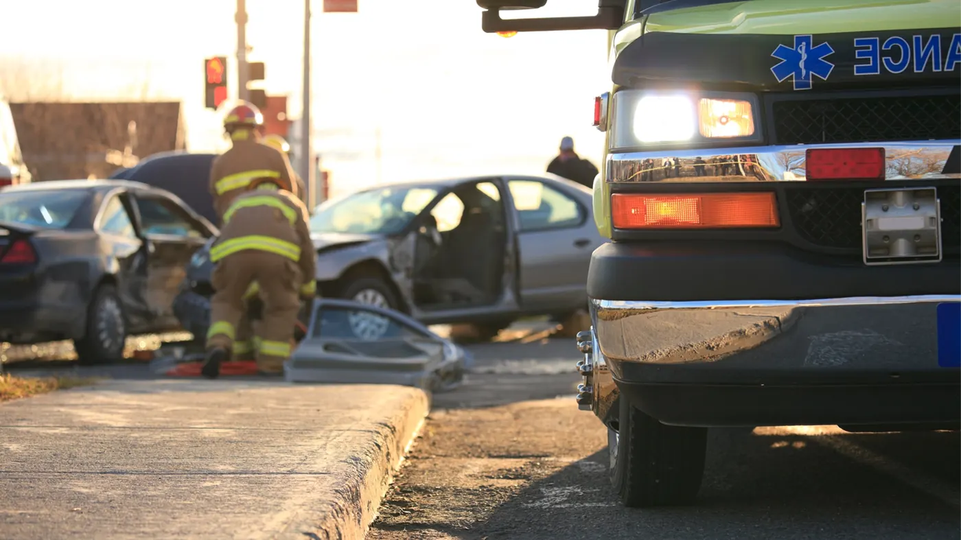 First responders working a car accident scene at an intersection